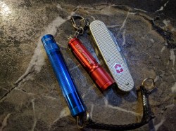 easy-to-find-the-dark-red-olight-i3-connected-to-victorinox-cadet-nd-maglite-solitaire-led